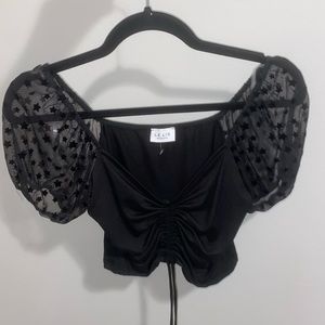 Black Le Lis top. Sheer star puff sleeves. Front tie. Size small.